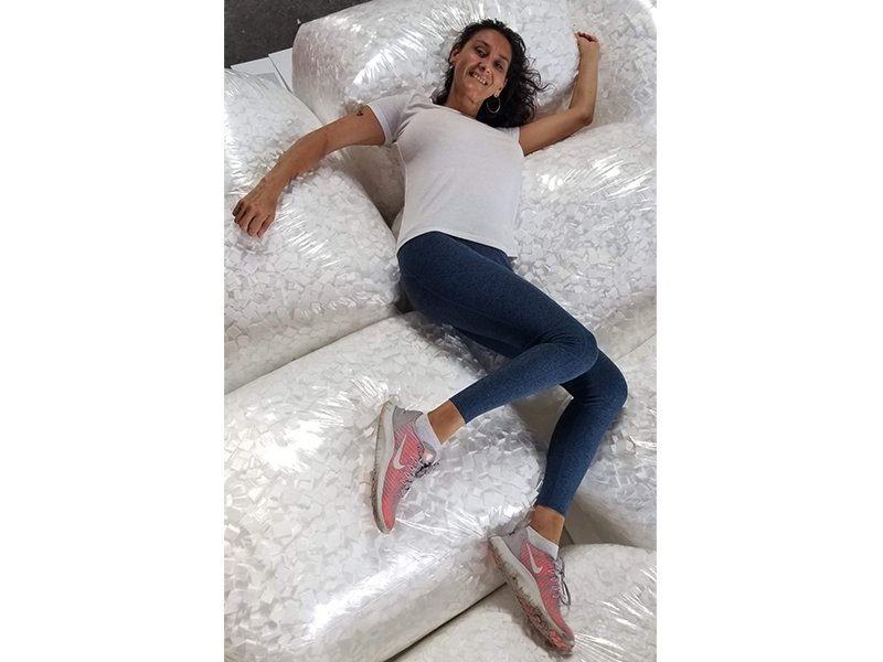 Girl laying on bags of packing peanuts loose fill